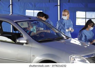 Bucharest, Romania - May 22, 2021: A Man Is Getting Covid-19 Vaccine In His Arm In His Car, In A Drive Thru Vaccination Centre In Bucharest, Romania.