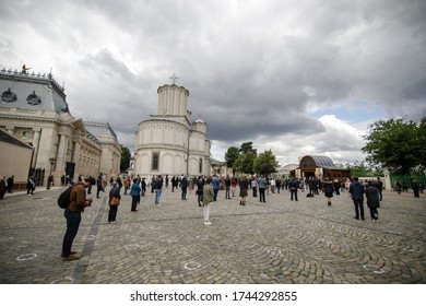 Bucharest, Romania - May 28, 2020: People Attend An Orthodox Church Service Outside The Patriarchal Palace With Social Distancing During The Covid-19 Outbreak.