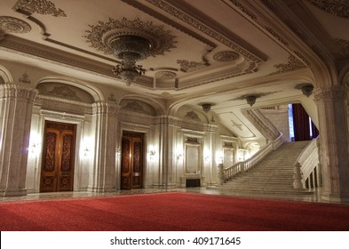 Bucharest, Romania - May 5, 2014: Interior of Palace of Parliament with chandelier, red carpet and main staircase.