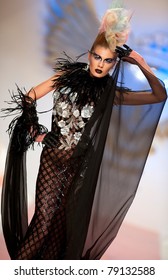 BUCHAREST, ROMANIA - MAY 7: Fashion model wears clothes made by Catalin Botezatu, Black Gold collection, in Bucharest Fashion Week at World Trade Center on May 7, 2011, Bucharest, Romania - Shutterstock ID 79132588