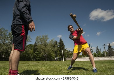 BUCHAREST, ROMANIA - MAY 8 Impact Moment/Player Rehearsing The Battering During Training Before An Important Oina Game. Oina Is A Traditional Romanian Game Which Supposedly Inspired Baseball. Bucharest, Romania, May 8, 2014