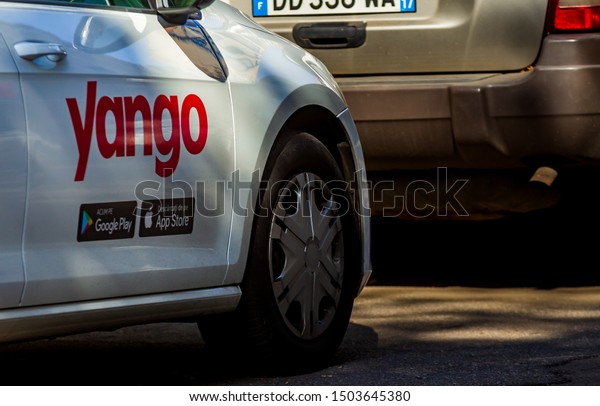 Bucharest, Romania - September 09, 2019: A car\
with the Yango logo of the multinational Yandex.Taxi BV belonging\
to Russian multinational corporation Yandex N.V. is parked on a\
street in Bucharest.