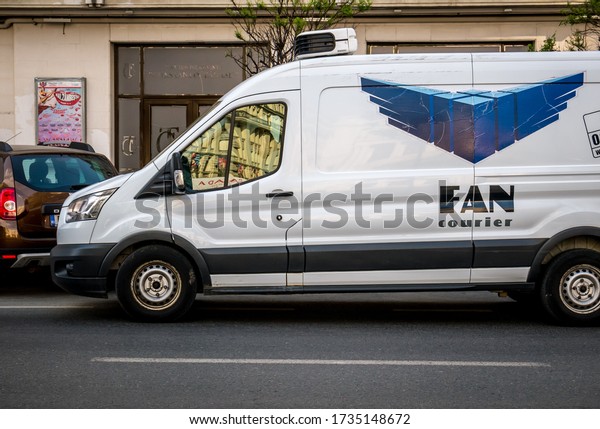 Bucharest/Romania - 05.16.2020:  A car or van\
with Fan Courier logo on the street. Fan Courier is the largest\
courier, delivery and postal company in\
Romania.