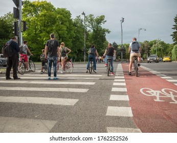 Bucharest/Romania - 06.05.2020: People On Bicycles At The Stop Light On A Cloudy Day.