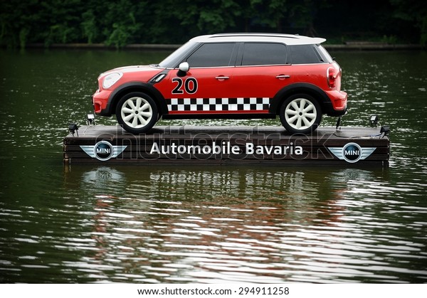 BUCHAREST/ROMANIA - JUNE 26: Advertising\
campaign with a Mini Cooper floating on a platform on a lake, on\
June 26, 2015 in\
Bucharest.