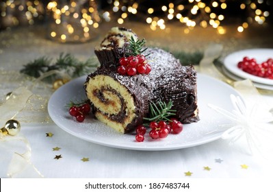 Buche di Noel. Christmas yule log cake on dark background. Traditional Christmas dessert. Selective focus.