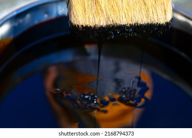 Bucket Of Black Paint With Brush