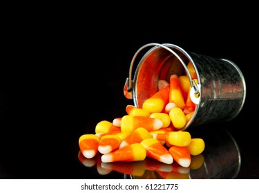 Bucket Of Candy Corn On A Black Background With Reflection