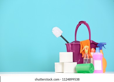 Bucket With Cleaning Supplies On Color Background