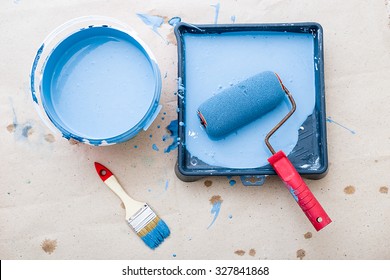 A Bucket Of Paint And A Brush Roller Paint Tray