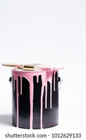 Bucket Of Pink Paint With Dripping Paintbrush On A White Background With Copy Space.