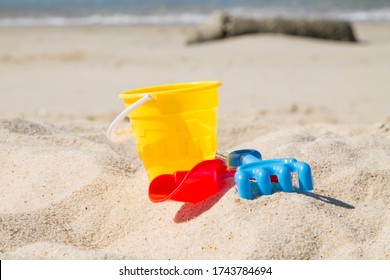 Bucket, Shovel, Rake On The Beach Sand