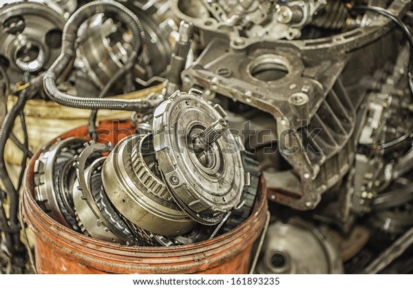 Bucket of used and\
worn out automobile\
parts.