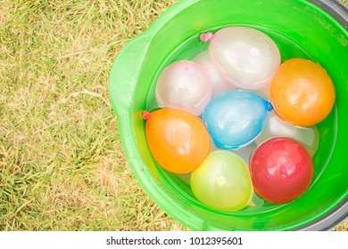 Bucket With Water Balloons Of Different Colors. Nature.
