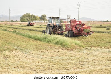 Buckeye, AZ. U.S.A. 9/8/2020. Ford 7710 Tractor Pulling A Hesston Alfalfa Baler.
