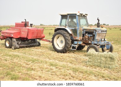 Buckeye, AZ. U.S.A. 9/8/2020. Ford 7710 Tractor Pulling A Hesston Alfalfa Baler.
