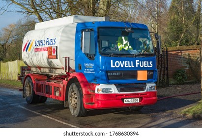 BUCKINGHAM, UK - February 15, 2018. Lovell Fuels Heating Oil Delivery. A Tanker Lorry Delivering Domestic Heating Oil (kerosene), Filling An Oil Tank At A Rural Home