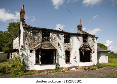 BUCKINGHAMSHIRE, UK - August 10, 2021. Fire Damaged House. Building With Burnt Down Roof And Blackened Walls.