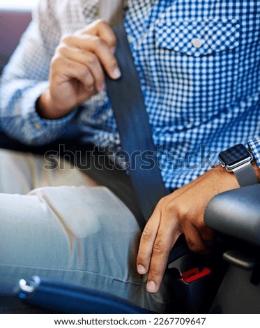 Buckle up and keep safe. Cropped shot of an unidentifiable man fastening his seatbelt in a vehicle.