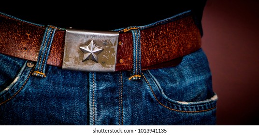 buckle star, jeans and close up.