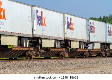 Bucklin, Missouri / United States - August 11, 2018: FedEx Ground Shipping Trailers Ride The Rails Aboard A High Priority BNSF Intermodal Train.