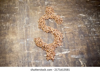 Buckwheat grains in the form of a dollar. Rise in the cost of food due to the war in Ukraine - Shutterstock ID 2171613581
