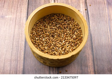 The Buckwheat natural. A grain of buckwheat. Buckwheat in a wooden jar. Buckwheat and palms.