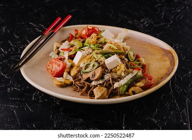 buckwheat noodles with grilled vegetables on plate - Shutterstock ID 2250522487