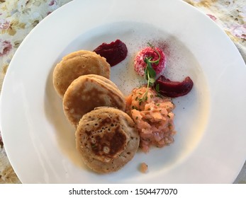 Buckwheat And Wheat Pancakes Called Blini (bliny) Served With Salmon Tartare, Beetroot And Horse Radish Cream. Traditional Russian Cuisine, And Eastern European Cuisine.