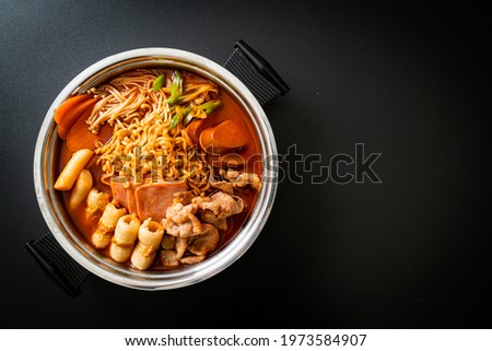 Budae Jjigae or Budaejjigae (Army stew or Army base stew). It is loaded with Kimchi, spam, sausages, ramen noodles and much more - popular Korean hot pot food style