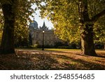 Budapest City Park (varosliget in Hungarian) during a beautiful autumn day, with orange vivid trees and lake in the middle of this park from Hungary. Sunny autumn day. Travel to Budapest.