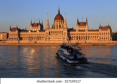 Budapest, Hungarian Parliament With Boat On The Danube At The Sunset