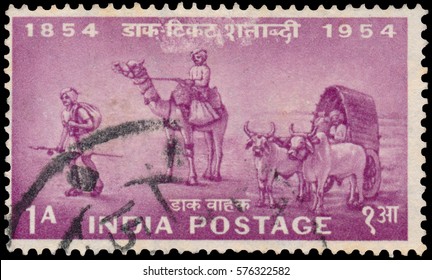 BUDAPEST, HUNGARY - 02 november 2015: stamp printed in India with image of Indian postal workers on foot, camel and the bullock cart to commemorate the centenary of Indian postage services; circa 1954
