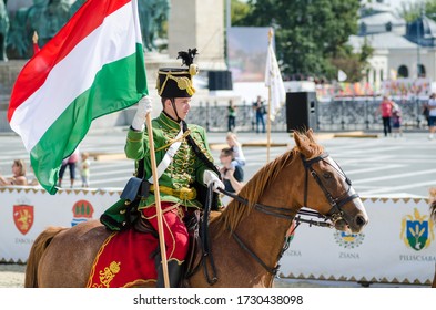 Budapest / Hungary - 09/19/2015: Man In Traditional Military Uniform Riding A Horse And Carrying The Hungarian Flag During The Cultural Heritage Days' Festival