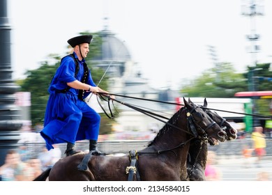 Budapest, Hungary - 09.19.2015: Panning shot of a horse rider standing on the horses' back during the Cultural Heritage Days festival at Heroes' Square