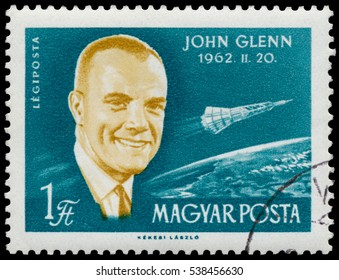 BUDAPEST, HUNGARY - 14 December 2016:  A Stamp Printed In Hungary Shows American Astronaut John Glenn; Astronauts Series Circa 1962