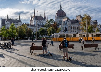 Budapest, Hungary - 1st September 2022: People Walking On The Street With The Hungarian Parliament Building In Background