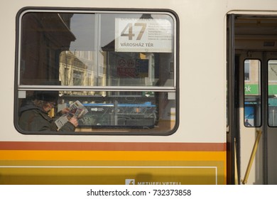 Budapest, Hungary- 27 January, 2017: A Lonely Old Man Was Reading Newspaper While Waiting For The Train To Move In A Cold Winter Morning.