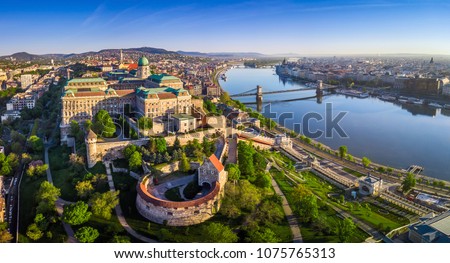 Budapest, Hungary - Aerial panoramic skyline view of Buda Castle Royal Palace with Szechenyi Chain Bridge, St.Stephen's Basilica, Hungarian Parliament and Matthias Church at sunrise with blue sky