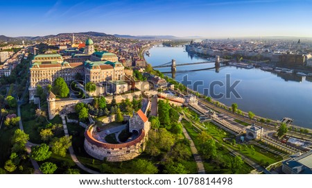 Budapest, Hungary - Aerial panoramic skyline view of Buda Castle Royal Palace with Szechenyi Chain Bridge, St.Stephen's Basilica, Hungarian Parliament and Matthias Church at sunrise with blue sky
