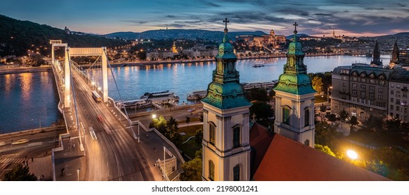 Budapest, Hungary - Aerial panoramic view of Budapest at dusk. This view includes Inner-City Mother Church of Our Lady of the Assumption, Elisabeth Bridge and Buda Castle Royal Palace at background - Shutterstock ID 2198001241