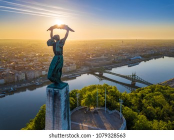 Budapest, Hungary - Aerial view of the beautiful Hungarian Statue of Liberty with Liberty Bridge and skyline of Budapest at sunrise with clear blue sky