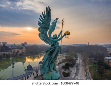 Budapest, Hungary - Aerial view of Gabriel Archangel at Heroes' Square during the 2020 Coronavirus quarantine in the morning. Vajdahunyad Castle and City Park at background with a warm sunrise