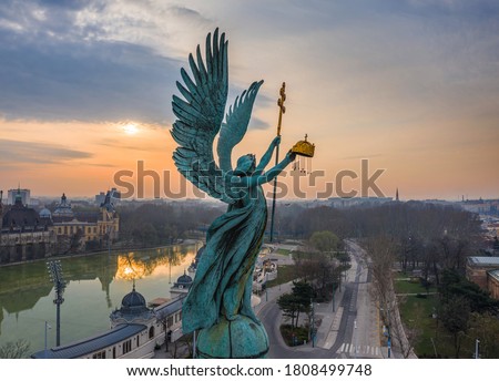 Budapest, Hungary - Aerial view of Gabriel Archangel at Heroes' Square during the 2020 Coronavirus quarantine in the morning. Vajdahunyad Castle and City Park at background with a warm sunrise