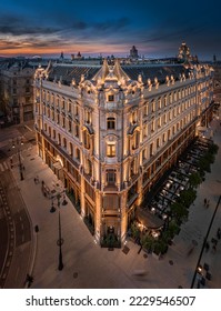 Budapest, Hungary - Aerial view of a renovated illuminated luxury collection hotel Matild Palace at Ferenciek tere after sunset at downtown Budapest with colorful golden and blue sky on a summer night