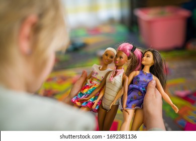 Budapest, Hungary / April 1, 2019 - Young Girl Playing With Her Barbie Toy Dolls Of Diverse Variety. Educating Diversity Concept. Illustrative Editorial.