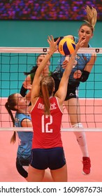 BUDAPEST, HUNGARY – August 23, 2019: Beta Dumancic (red 12) posts the ball, at the Croatia(red) – Azerbaijan (blue) 2019 CEV Volleyball European Championship’s women volleyball game.