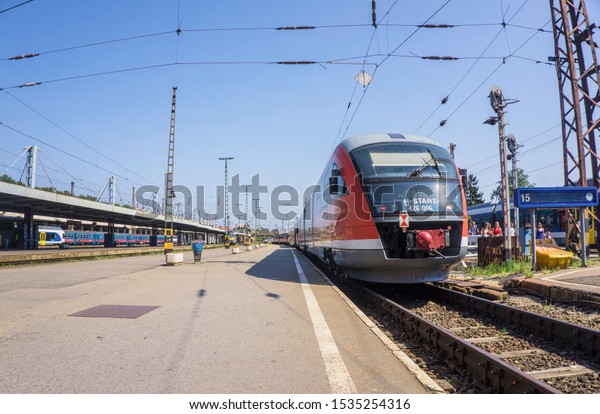 Budapest / Hungary - August 29 2019: platform of the old\
Nyugati Palyaudvar railway station and passenger cars in Budapest,\
Hungary. Railway public transport in Europe. Ancient building and\
tourists 