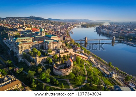 Budapest, Hungary - Beautiful aerial skyline view of Buda Castle Royal Palace and South Rondella at sunset with Szechenyi Chain Bridge over River Danube, Matthias Church and Parliament of Hungary