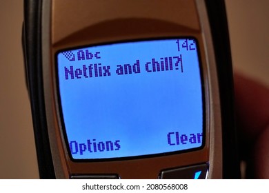 Budapest, Hungary - Circa 2021: Sms Text Message Saying Netflix And Chill On An Old Mobile Phone Screen